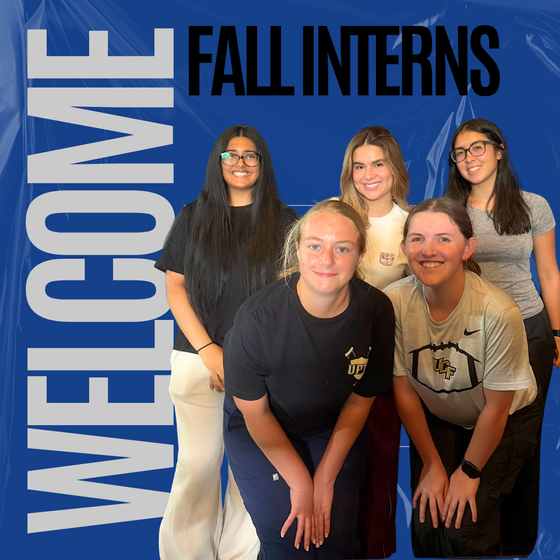 A group photo of five young women smiling and posing together in front of a bright blue graphic background with a subtle plastic wrap overlay texture. Large vertical gray block text on the left reads "WELCOME," and bold black lettering across the top right reads "FALL INTERNS."